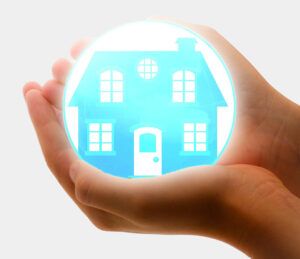 hands cradling globe with home to represent house insurance