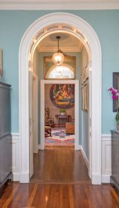 Arched doorway in a historic house with detailed molding.