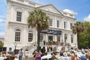 Charleston City Hall with banner for Spoleto Festival and a crowd in front