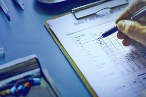 clipboard with a hand conducting a security risk assessment checklist