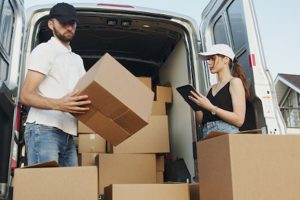 Professional movers putting boxes in a moving van.