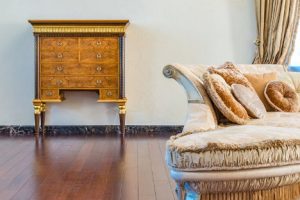 antique beige sofa and wooden chest