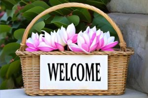 basket of magnolia flowers with a welcome sign