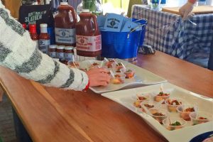 Person grabbing a sample of food at the Charleston Wine and Food festival