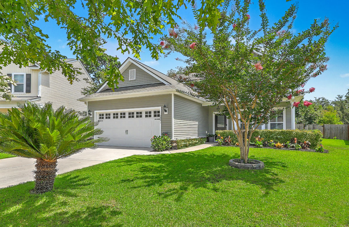 3091 Vincent Astor Drive: 1-story home with lush green lawn and beautiful landscaping for sale in Oakfield on Johns Island, SC
